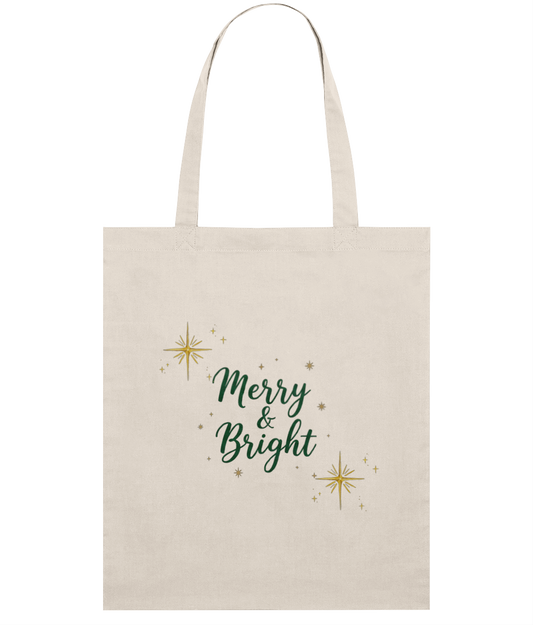 Beige tote bag with 'Merry & Bright' text and star designs on a white background